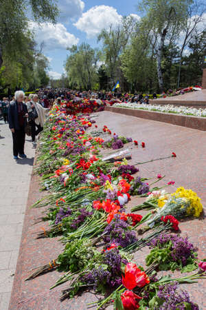 ODESSA, UKRAINE - MAY 9, 2021: Memorial of Unknown Sailor of Eternal Flame to defenders of Fatherland with flowers by fire. "Eternal Flame" in memorial to fallen defenders of Fatherland. Victory Dayのeditorial素材