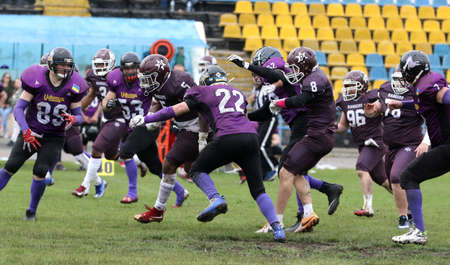 ODESSA, UKRAINE - May 30, 2021: American football on the grass. A tough duel, a battle between...