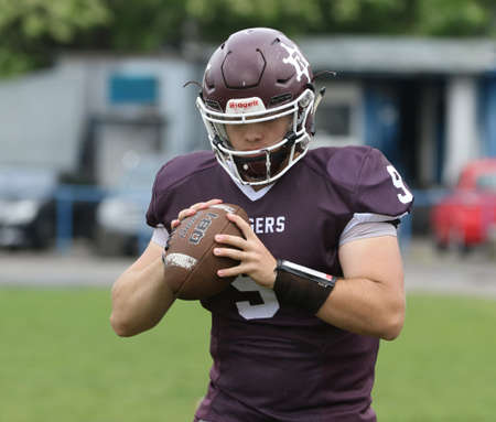 ODESSA, UKRAINE - May 30, 2021: American football on the grass. A tough duel, a battle between Odessa REINGERS and Nikolaev VIKINGS on the wet lawn of stadium. Tough American Football Athletes Battleのeditorial素材