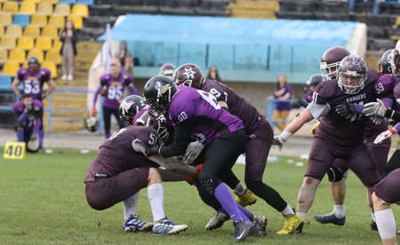 ODESSA, UKRAINE - May 30, 2021: American football on the grass. A tough duel, a battle between...