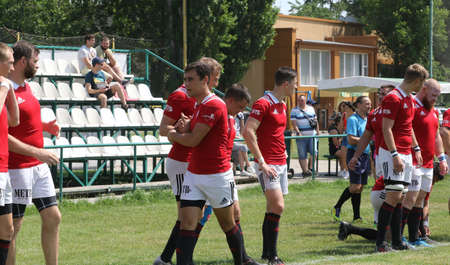 Odessa, Ukraine - June 23, 2021: Odessa National Team CREDO (red) - OLYMP-Kharkiv (yellow) in rugby 7s. Sharp aggressive fight of male rugby players for ball. Dynamic play on green grass of stadiumのeditorial素材