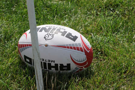 Odessa, Ukraine - June 23, 2021: Odessa National Team CREDO (red) - OLYMP-Kharkiv (yellow) in rugby 7s. Sharp aggressive fight of male rugby players for ball. Dynamic play on green grass of stadiumのeditorial素材