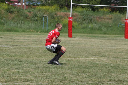 Odessa, Ukraine - June 23, 2021: Odessa National Team CREDO (red) - OLYMP-Kharkiv (yellow) in rugby 7s. Sharp aggressive fight of male rugby players for ball. Dynamic play on green grass of stadiumのeditorial素材