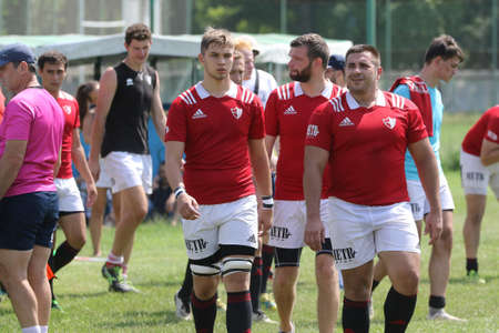 Odessa, Ukraine - June 23, 2021: Odessa National Team CREDO (red) - OLYMP-Kharkiv (yellow) in rugby 7s. Sharp aggressive fight of male rugby players for ball. Dynamic play on green grass of stadiumのeditorial素材