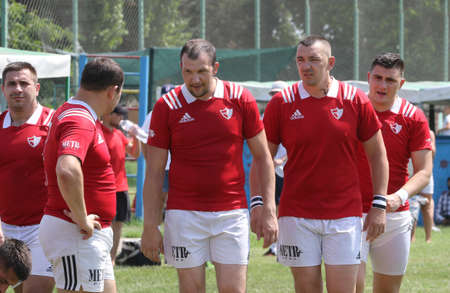 Odessa, Ukraine - June 23, 2021: Odessa National Team CREDO (red) - OLYMP-Kharkiv (yellow) in rugby 7s. Sharp aggressive fight of male rugby players for ball. Dynamic play on green grass of stadiumのeditorial素材