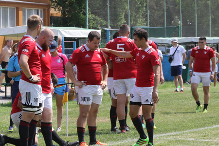 Odessa, Ukraine - June 23, 2021: Odessa National Team CREDO (red) - OLYMP-Kharkiv (yellow) in rugby 7s. Sharp aggressive fight of male rugby players for ball. Dynamic play on green grass of stadiumのeditorial素材