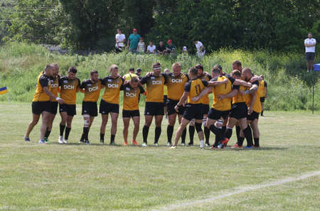 Odessa, Ukraine - June 23, 2021: Odessa National Team CREDO (red) - OLYMP-Kharkiv (yellow) in rugby 7s. Sharp aggressive fight of male rugby players for ball. Dynamic play on green grass of stadiumのeditorial素材