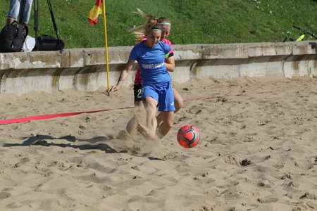ODESSA, UKRAINE July 8, 2021: Ukrainian Beach Soccer Women's Cup. The girl's footballers are desperately playing beach soccer on sand of sea city beach on a hot sunny day. Women's soccer on sandのeditorial素材