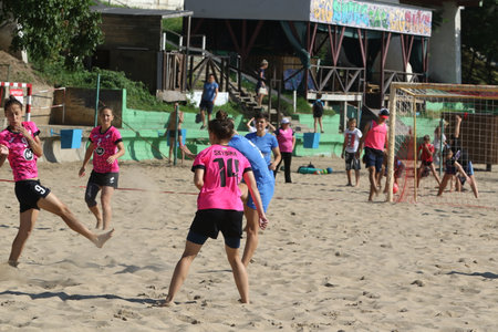 ODESSA, UKRAINE July 8, 2021: Ukrainian Beach Soccer Women's Cup. The girl's footballers are desperately playing beach soccer on sand of sea city beach on a hot sunny day. Women's soccer on sandのeditorial素材
