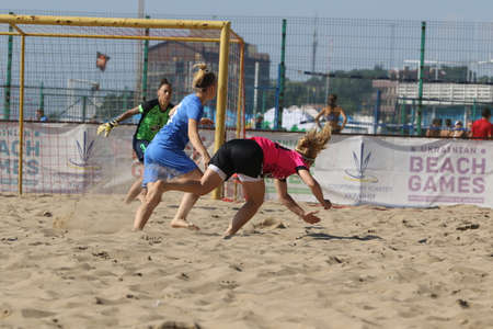 ODESSA, UKRAINE July 8, 2021: Ukrainian Beach Soccer Women's Cup. The girl's footballers are desperately playing beach soccer on sand of sea city beach on a hot sunny day. Women's soccer on sandのeditorial素材