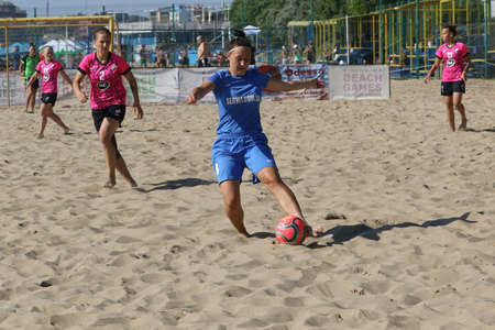 ODESSA, UKRAINE July 8, 2021: Ukrainian Beach Soccer Women's Cup. The girl's footballers are desperately playing beach soccer on sand of sea city beach on a hot sunny day. Women's soccer on sandのeditorial素材