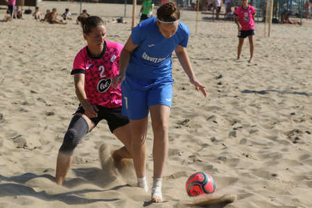 ODESSA, UKRAINE July 8, 2021: Ukrainian Beach Soccer Women's Cup. The girl's footballers are desperately playing beach soccer on sand of sea city beach on a hot sunny day. Women's soccer on sandのeditorial素材