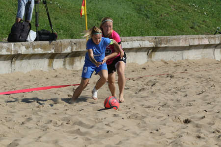 ODESSA, UKRAINE July 8, 2021: Ukrainian Beach Soccer Women's Cup. The girl's footballers are desperately playing beach soccer on sand of sea city beach on a hot sunny day. Women's soccer on sandのeditorial素材