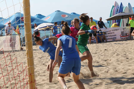 ODESSA, UKRAINE July 8, 2021: Ukrainian Beach Soccer Women's Cup. The girl's footballers are desperately playing beach soccer on sand of sea city beach on a hot sunny day. Women's soccer on sandのeditorial素材