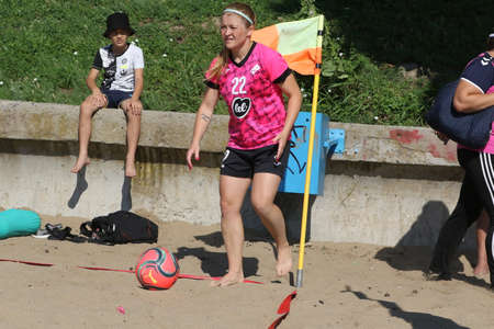 ODESSA, UKRAINE July 8, 2021: Ukrainian Beach Soccer Women's Cup. The girl's footballers are desperately playing beach soccer on sand of sea city beach on a hot sunny day. Women's soccer on sandのeditorial素材