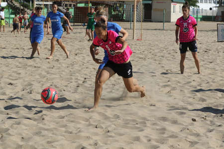ODESSA, UKRAINE July 8, 2021: Ukrainian Beach Soccer Women's Cup. The girl's footballers are desperately playing beach soccer on sand of sea city beach on a hot sunny day. Women's soccer on sandのeditorial素材