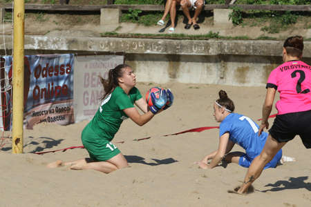 ODESSA, UKRAINE July 8, 2021: Ukrainian Beach Soccer Women's Cup. The girl's footballers are desperately playing beach soccer on sand of sea city beach on a hot sunny day. Women's soccer on sandのeditorial素材