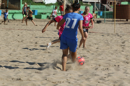 ODESSA, UKRAINE July 8, 2021: Ukrainian Beach Soccer Women's Cup. The girl's footballers are desperately playing beach soccer on sand of sea city beach on a hot sunny day. Women's soccer on sandのeditorial素材