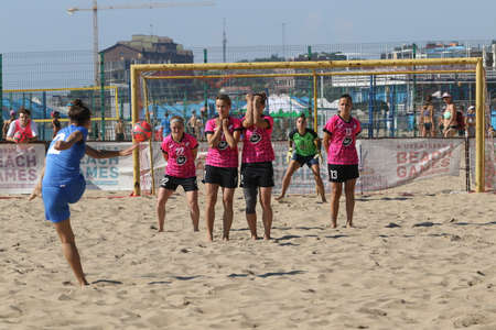 ODESSA, UKRAINE July 8, 2021: Ukrainian Beach Soccer Women's Cup. The girl's footballers are desperately playing beach soccer on sand of sea city beach on a hot sunny day. Women's soccer on sandのeditorial素材