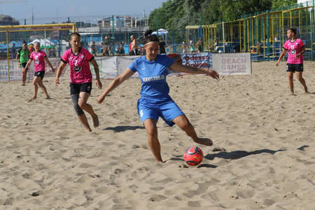 ODESSA, UKRAINE July 8, 2021: Ukrainian Beach Soccer Women's Cup. The girl's footballers are desperately playing beach soccer on sand of sea city beach on a hot sunny day. Women's soccer on sandのeditorial素材