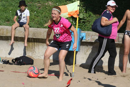 ODESSA, UKRAINE July 8, 2021: Ukrainian Beach Soccer Women's Cup. The girl's footballers are desperately playing beach soccer on sand of sea city beach on a hot sunny day. Women's soccer on sandのeditorial素材