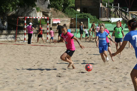 ODESSA, UKRAINE July 8, 2021: Ukrainian Beach Soccer Women's Cup. The girl's footballers are desperately playing beach soccer on sand of sea city beach on a hot sunny day. Women's soccer on sandのeditorial素材