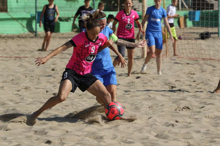ODESSA, UKRAINE July 8, 2021: Ukrainian Beach Soccer Women's Cup. The girl's footballers are desperately playing beach soccer on sand of sea city beach on a hot sunny day. Women's soccer on sandのeditorial素材
