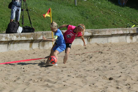 ODESSA, UKRAINE July 8, 2021: Ukrainian Beach Soccer Women's Cup. The girl's footballers are desperately playing beach soccer on sand of sea city beach on a hot sunny day. Women's soccer on sandのeditorial素材
