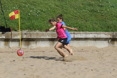 ODESSA, UKRAINE July 8, 2021: Ukrainian Beach Soccer Women's Cup. The girl's footballers are desperately playing beach soccer on sand of sea city beach on a hot sunny day. Women's soccer on sandのeditorial素材