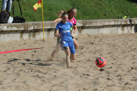 ODESSA, UKRAINE July 8, 2021: Ukrainian Beach Soccer Women's Cup. The girl's footballers are desperately playing beach soccer on sand of sea city beach on a hot sunny day. Women's soccer on sandのeditorial素材