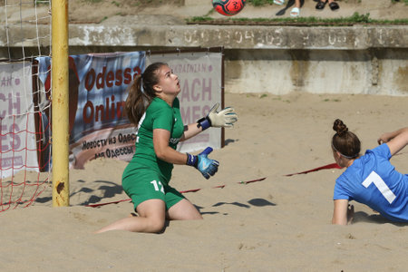 ODESSA, UKRAINE July 8, 2021: Ukrainian Beach Soccer Women's Cup. The girl's footballers are desperately playing beach soccer on sand of sea city beach on a hot sunny day. Women's soccer on sandのeditorial素材