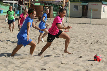 ODESSA, UKRAINE July 8, 2021: Ukrainian Beach Soccer Women's Cup. The girl's footballers are desperately playing beach soccer on sand of sea city beach on a hot sunny day. Women's soccer on sandのeditorial素材