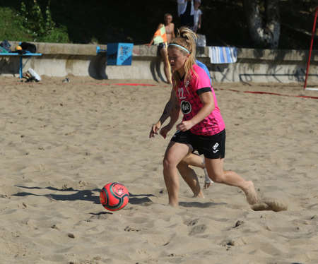 ODESSA, UKRAINE July 8, 2021: Ukrainian Beach Soccer Women's Cup. The girl's footballers are desperately playing beach soccer on sand of sea city beach on a hot sunny day. Women's soccer on sandのeditorial素材