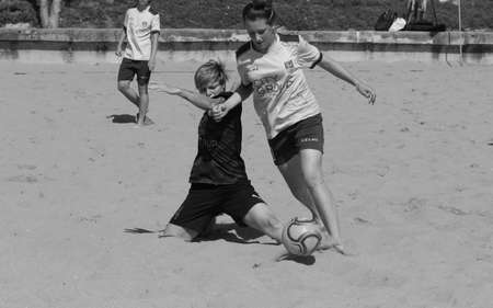 ODESSA, UKRAINE July 8, 2021: Ukrainian Beach Soccer Women's Cup. The girl's footballers are desperately playing beach soccer on sand of sea city beach on a hot sunny day. Women's soccer on sandのeditorial素材