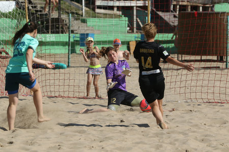 ODESSA, UKRAINE July 8, 2021: Ukrainian Beach Soccer Women's Cup. The girl's footballers are desperately playing beach soccer on sand of sea city beach on a hot sunny day. Women's soccer on sandのeditorial素材