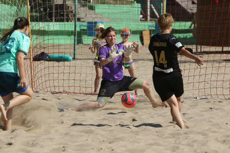 ODESSA, UKRAINE July 8, 2021: Ukrainian Beach Soccer Women's Cup. The girl's footballers are desperately playing beach soccer on sand of sea city beach on a hot sunny day. Women's soccer on sandのeditorial素材