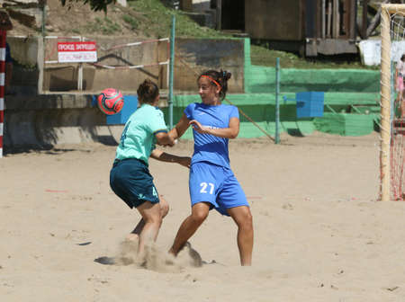ODESSA, UKRAINE July 8, 2021: Ukrainian Beach Soccer Women's Cup. The girl's footballers are desperately playing beach soccer on sand of sea city beach on a hot sunny day. Women's soccer on sandのeditorial素材