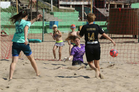 ODESSA, UKRAINE July 8, 2021: Ukrainian Beach Soccer Women's Cup. The girl's footballers are desperately playing beach soccer on sand of sea city beach on a hot sunny day. Women's soccer on sandのeditorial素材
