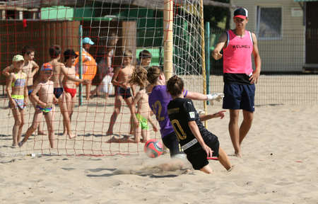 ODESSA, UKRAINE July 8, 2021: Ukrainian Beach Soccer Women's Cup. The girl's footballers are desperately playing beach soccer on sand of sea city beach on a hot sunny day. Women's soccer on sandのeditorial素材