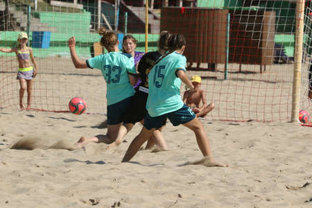 ODESSA, UKRAINE July 8, 2021: Ukrainian Beach Soccer Women's Cup. The girl's footballers are desperately playing beach soccer on sand of sea city beach on a hot sunny day. Women's soccer on sandのeditorial素材