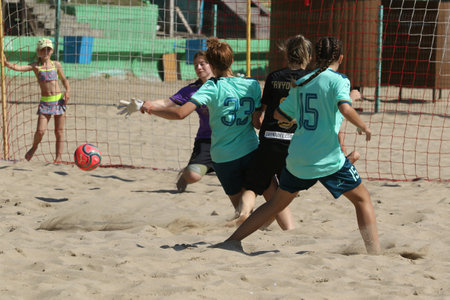 ODESSA, UKRAINE July 8, 2021: Ukrainian Beach Soccer Women's Cup. The girl's footballers are desperately playing beach soccer on sand of sea city beach on a hot sunny day. Women's soccer on sandのeditorial素材