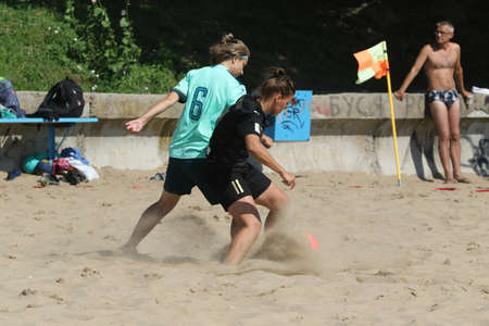 ODESSA, UKRAINE July 8, 2021: Ukrainian Beach Soccer Women's Cup. The girl's footballers are desperately playing beach soccer on sand of sea city beach on a hot sunny day. Women's soccer on sandのeditorial素材