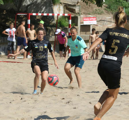 ODESSA, UKRAINE July 8, 2021: Ukrainian Beach Soccer Women's Cup. The girl's footballers are desperately playing beach soccer on sand of sea city beach on a hot sunny day. Women's soccer on sandのeditorial素材