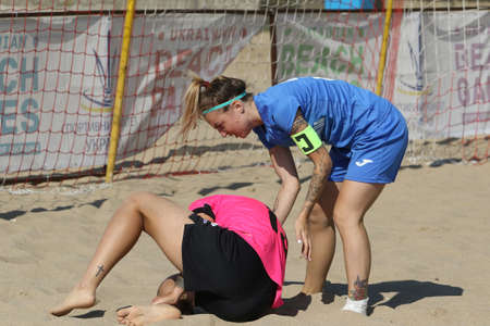 ODESSA, UKRAINE July 8, 2021: Ukrainian Beach Soccer Women's Cup. The girl's footballers are desperately playing beach soccer on sand of sea city beach on a hot sunny day. Women's soccer on sandのeditorial素材
