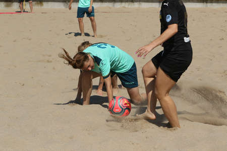 ODESSA, UKRAINE July 8, 2021: Ukrainian Beach Soccer Women's Cup. The girl's footballers are desperately playing beach soccer on sand of sea city beach on a hot sunny day. Women's soccer on sandのeditorial素材