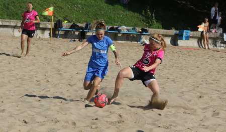 ODESSA, UKRAINE July 8, 2021: Ukrainian Beach Soccer Women's Cup. The girl's footballers are desperately playing beach soccer on sand of sea city beach on a hot sunny day. Women's soccer on sandのeditorial素材