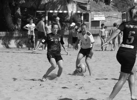 ODESSA, UKRAINE July 8, 2021: Ukrainian Beach Soccer Women's Cup. The girl's footballers are desperately playing beach soccer on sand of sea city beach on a hot sunny day. Women's soccer on sandのeditorial素材