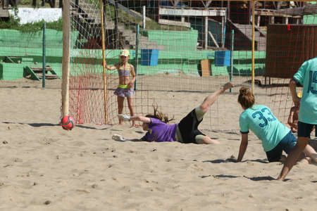 ODESSA, UKRAINE July 8, 2021: Ukrainian Beach Soccer Women's Cup. The girl's footballers are desperately playing beach soccer on sand of sea city beach on a hot sunny day. Women's soccer on sandのeditorial素材