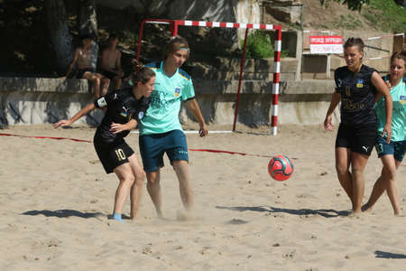 ODESSA, UKRAINE July 8, 2021: Ukrainian Beach Soccer Women's Cup. The girl's footballers are desperately playing beach soccer on sand of sea city beach on a hot sunny day. Women's soccer on sandのeditorial素材