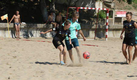 ODESSA, UKRAINE July 8, 2021: Ukrainian Beach Soccer Women's Cup. The girl's footballers are desperately playing beach soccer on sand of sea city beach on a hot sunny day. Women's soccer on sandのeditorial素材